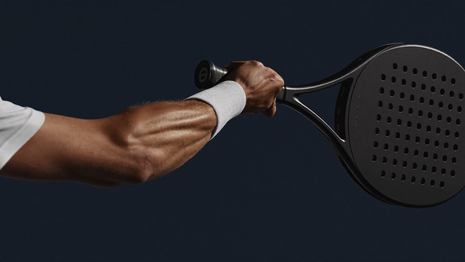 Padel player gripping a racquet at the handle